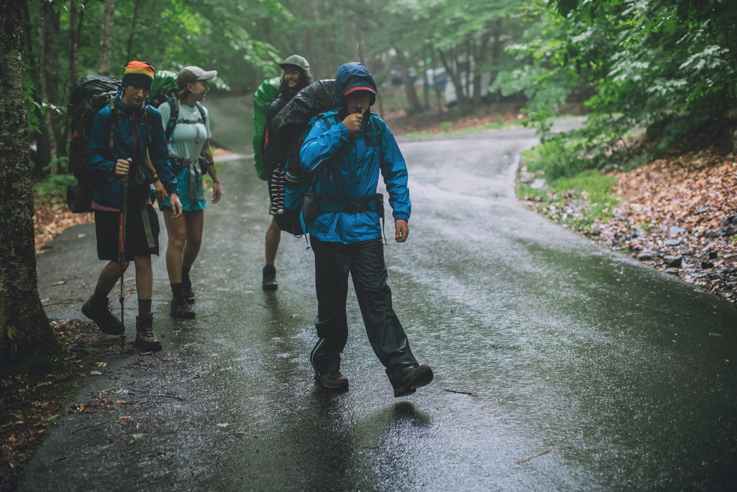 Hikers on a rainy trail.
