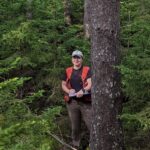 Carolyn ziegra standing in forest near tree